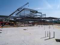 the construction site at the school is being constructed with metal rods and poles as they sit next to the open air