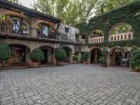 the courtyard is very large but has greenery and trees all around it for privacy