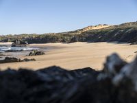 A Serene Beach in Portugal: The Perfect Ocean and Mountain Landscape