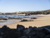 A Serene Beach in Portugal: The Perfect Ocean and Mountain Landscape