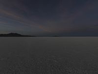 an area of empty open land on a cloudy day with clouds overhead, at the horizon