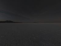 an area of empty open land on a cloudy day with clouds overhead, at the horizon