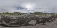 a skateboarder performs tricks in a park in the middle of nowhere on his skateboard