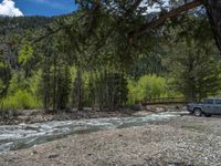 a forest is seen in this wide angle view in this photo from the bottom of the trail