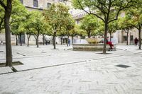 Scenic View of Seville Town Square with Historic Architecture and Tree-Lined Road