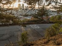 the sign is painted on the side of the street with a view of a city