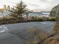 the sign is painted on the side of the street with a view of a city