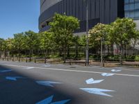 empty road with white lines on the streets of city area against cloudy blue sky on a sunny day