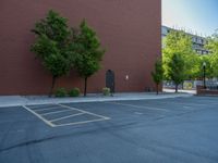 a paved street has been painted light gray, with gray brick walls and concrete edges