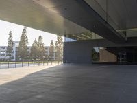 a shadow of someone walking around an empty building in a park with a skateboard