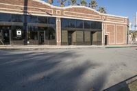 a shadow falls on the street while it passes by an office building on a sunny day