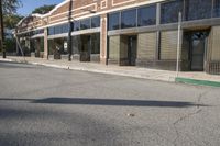 a shadow falls on the street while it passes by an office building on a sunny day