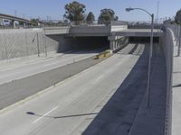 the shadows of two traffic lights on the highway overpasses, and an empty road underneath