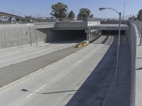 the shadows of two traffic lights on the highway overpasses, and an empty road underneath