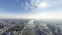 an aerial view of london from above with a large river running through the foreground