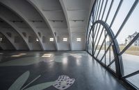 the walkway is decorated with black and white flower designs and blue, pink and yellow patterns