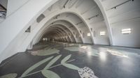 this is a picture of a large room that looks like a space with arches, a flower pattern on the floor and walls