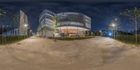 an image of a building that has some plants in it and lights on the ground