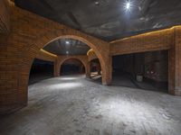 some brick arches and red bricks in a tunnel with a ceiling lit up by a light