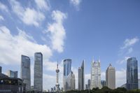 a river in front of a lot of buildings and a city skyline that is in the background