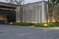 the courtyard features plants, lights and an enclosed area next to the entrance to the building