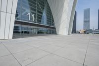 a building with a large amount of glass on it's side by another building