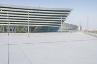 the view from an outdoor deck shows the empty plaza area and the building's large windows