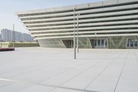 the view from an outdoor deck shows the empty plaza area and the building's large windows