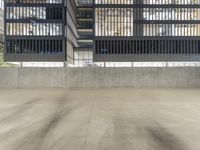 this is an empty concrete parking garage with a yellow fire hydrant in the center of it