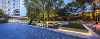 the garden area is illuminated up at night, with a water feature in the center