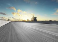 the sun is setting on the city skyline in a moving motion photograph taken on a bridge in the winter