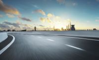 highway running along highway next to city skyline at twilight time and clouds in blue sky