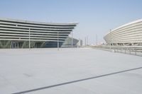 a man standing on top of a tiled patio next to building spaces holding a cell phone