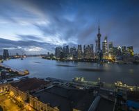 an elevated view shows the city of the future and its surroundings at dusk with the river passing by