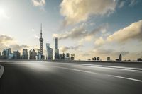 a large city skyline in the background with a roadway leading into the middle of it