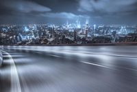 an image of a car driving through a city at night time time, in the motion