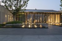 the courtyard of this building features a fountain and two steps leading into it with an awning area for a fire