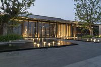 the courtyard area has a lighted fountain and benches at the end of it, where a pool runs out into the courtyard, for people to drink