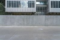 a skateboarder is skating past two buildings in the city alone a skate board