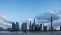 the large body of water has a few yellow barriers at it's sides and a city skyline is in the background