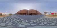 a very large building that looks like a dome, and some water stones are on the ground