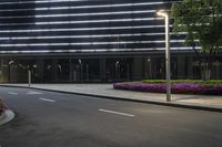 the entrance to this office building is lighted at night with multiple lights on the outside