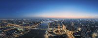 the view of the city at sunset, taken from above, and out, with a river