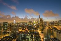 the city of chicago is illuminated at night, including one of many skyscrapers that tower over the city