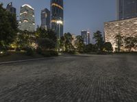 a cityscape with a clock tower stands in an empty park at night in shanghai