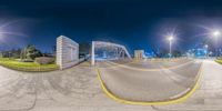 360 view of street at night in urban area with green park and pedestrian crossing with white building