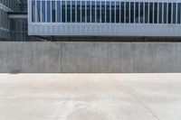 concrete building and street with yellow fire hydrant in front of it, outside, viewed from low to low on a sidewalk