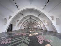 the empty space is decorated with flowers, with arches and light fixtures above them and below