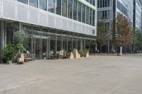 two men walking out of an office building on a clear day out front, some buildings are behind them