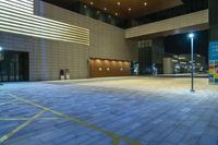 an empty building with some tall windows, lights, and brick flooring in front